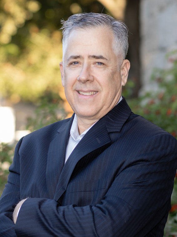 Greg Seright with arms crossed smiling