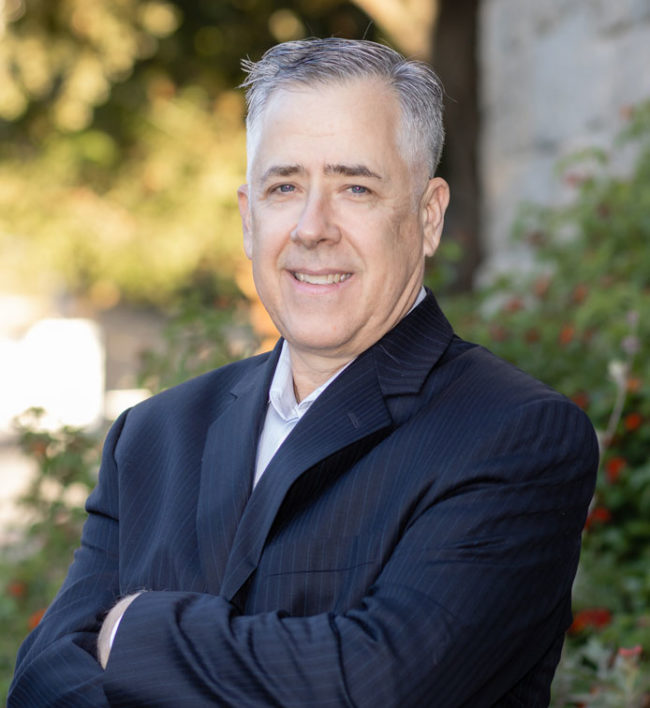 Greg Seright with arms crossed smiling