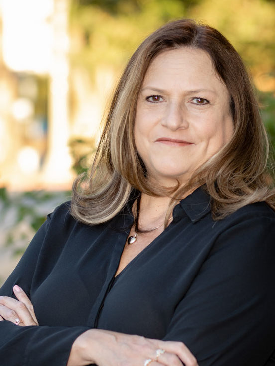 Linette Seright with her arms crossed smiling