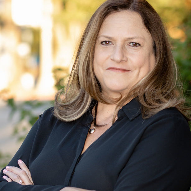 Linette Seright with her arms crossed smiling