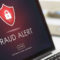 Laptop with Fraud Alert on the screen