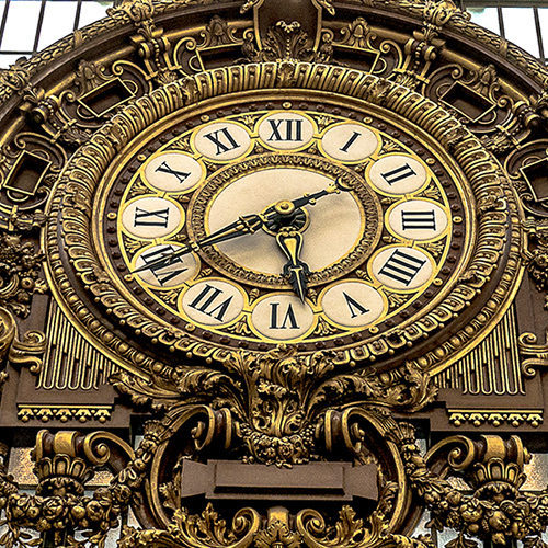 Gold clock hanging on a building