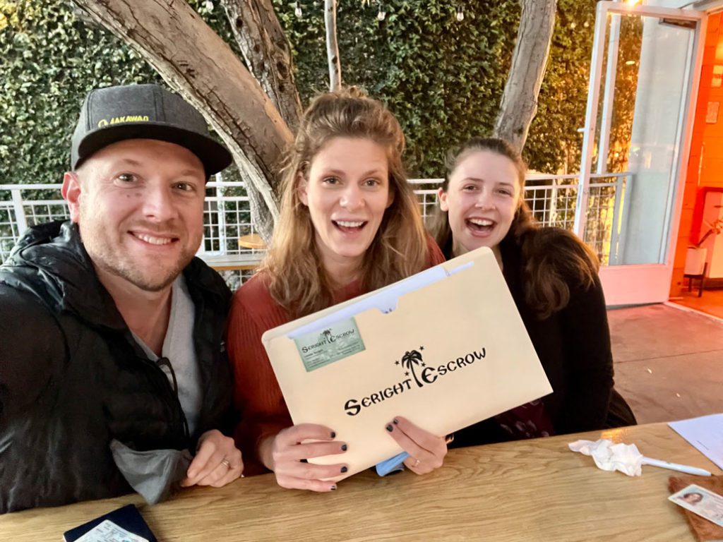 Happy couple sitting at a table with Jenna Seright.